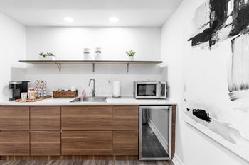 a kitchen with wooden cabinets and a sink and a microwave